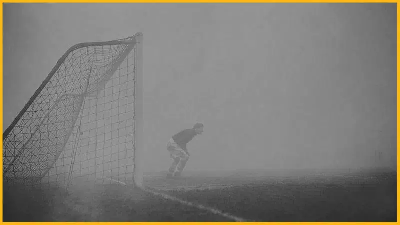 sam bartram standing in dense fog on a football field.